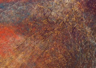 Abstract textured artwork with a mix of warm reds, oranges, and yellows blending into cooler blues and purples.